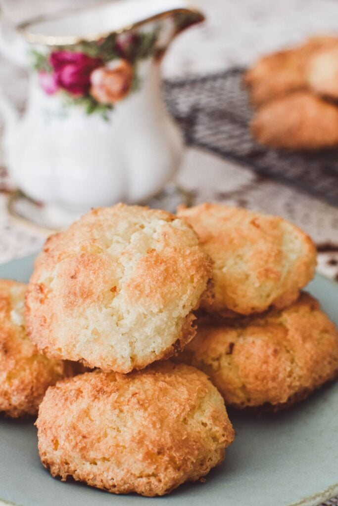 coconut biscuits on plate with Royal Albert jug in background.