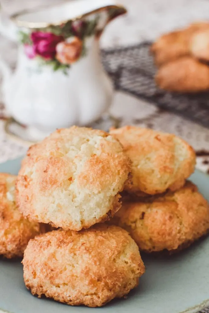 coconut biscuits on plate with Royal Albert jug in background.