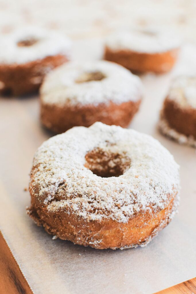 cinnamon doughnuts on baking paper.