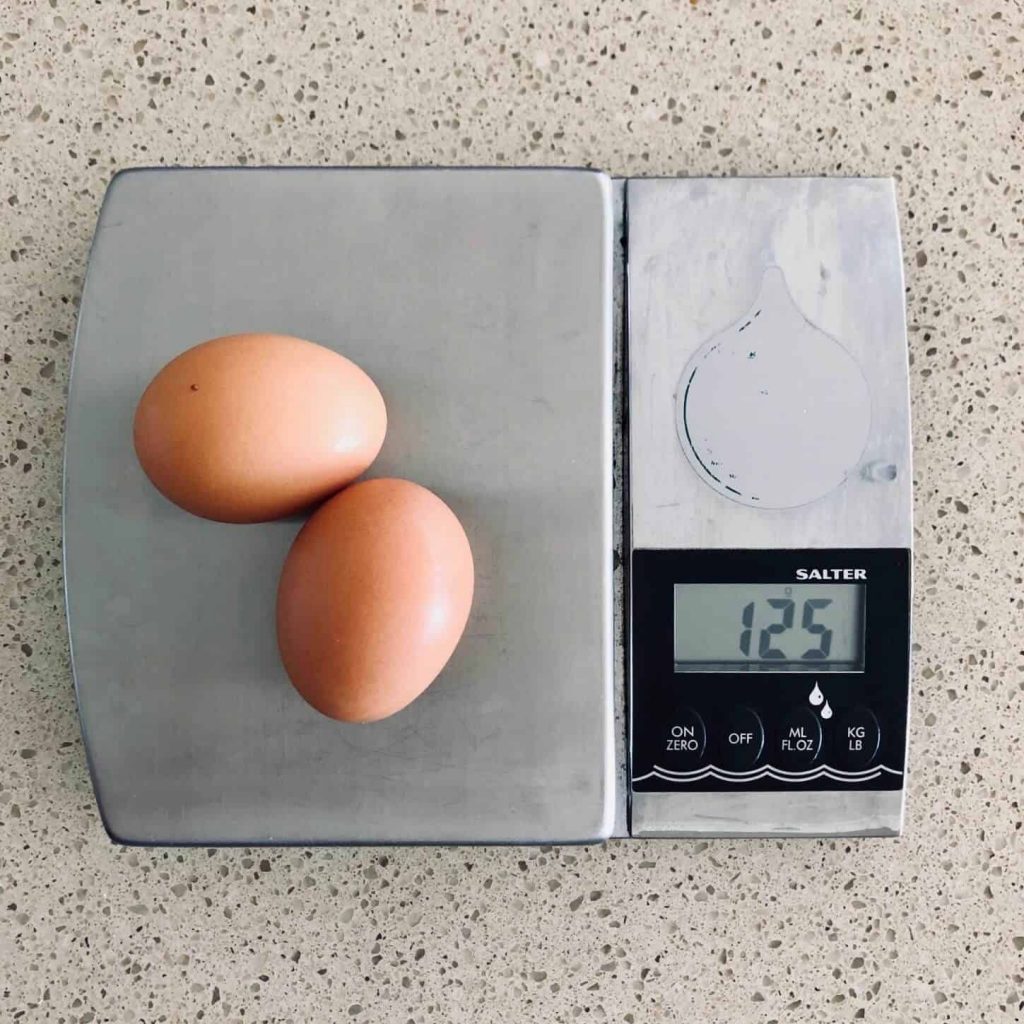 weighing eggs for butterfly cakes
