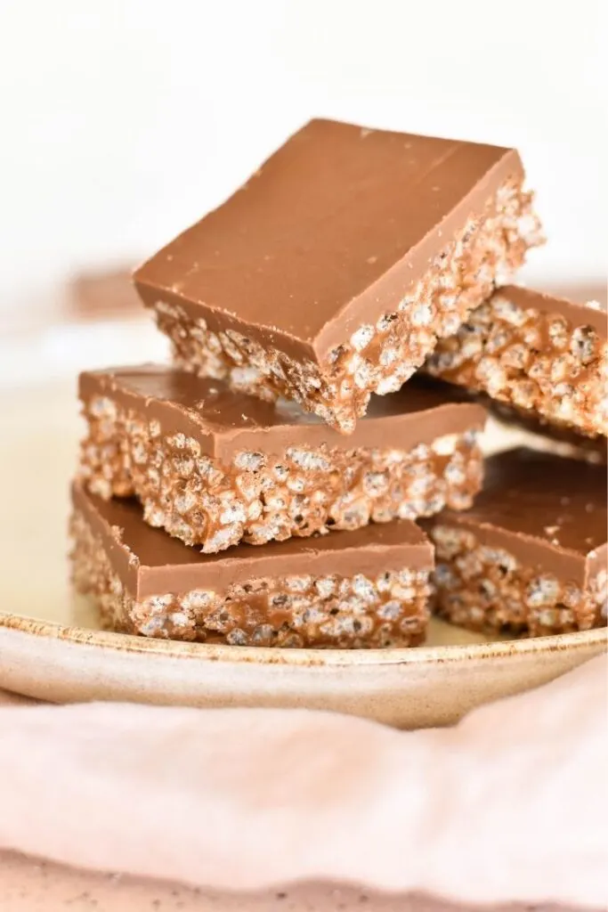 mars bar slice pieces sitting on plate with cloth in foreground