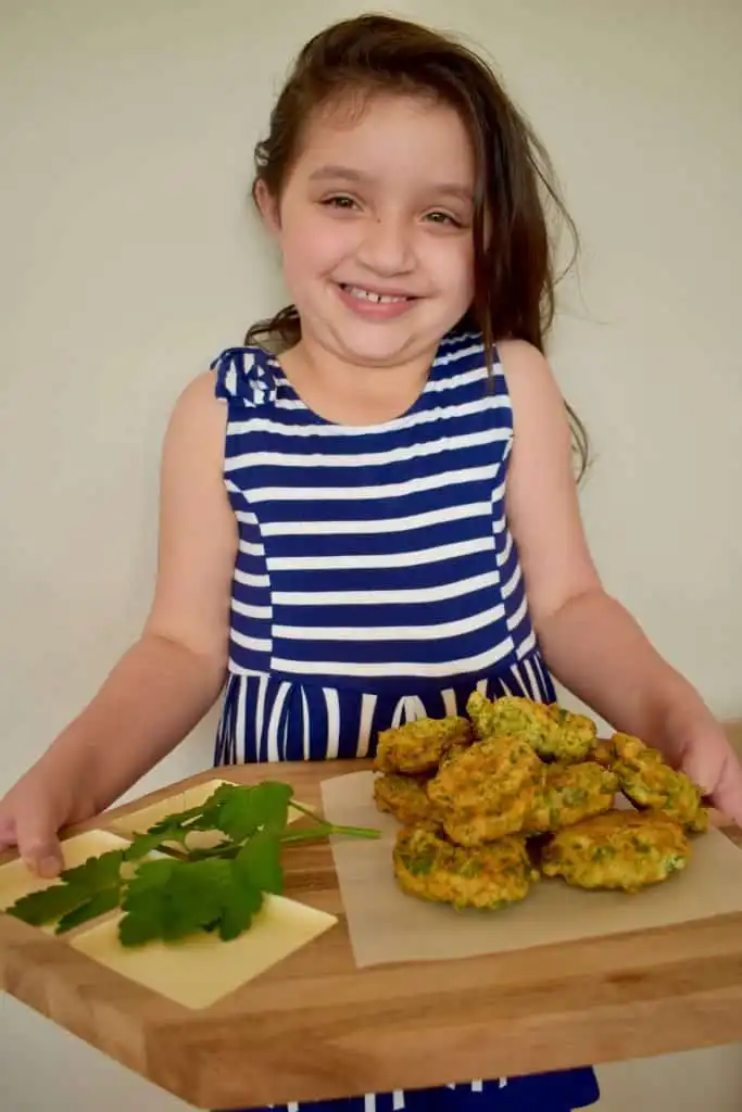 Miss Y holding the parsley fritters