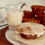 Carrot Christmas Pudding on plate with warm vanilla sauce poured over.