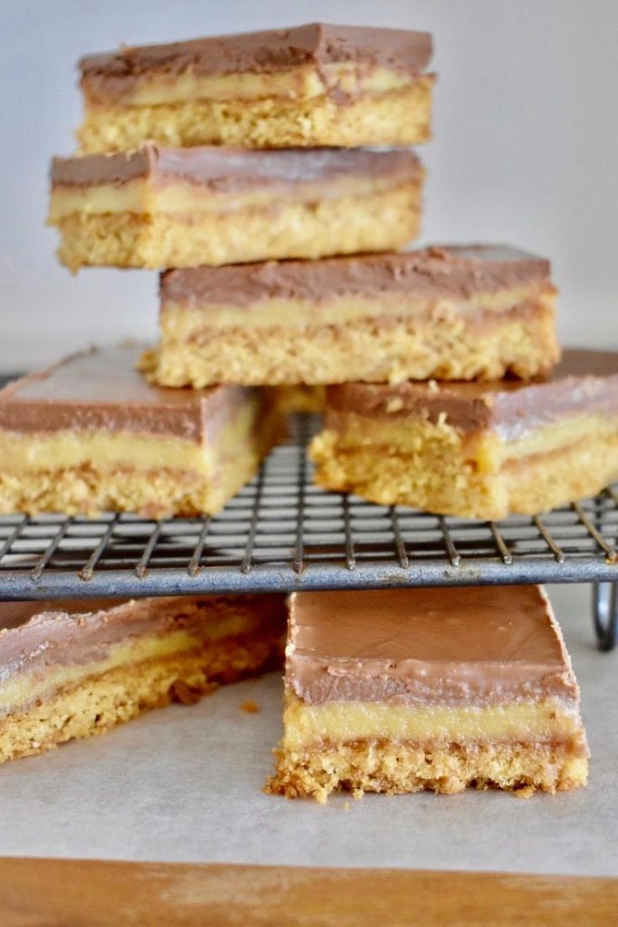 caramel slice stacked on a cooling tray