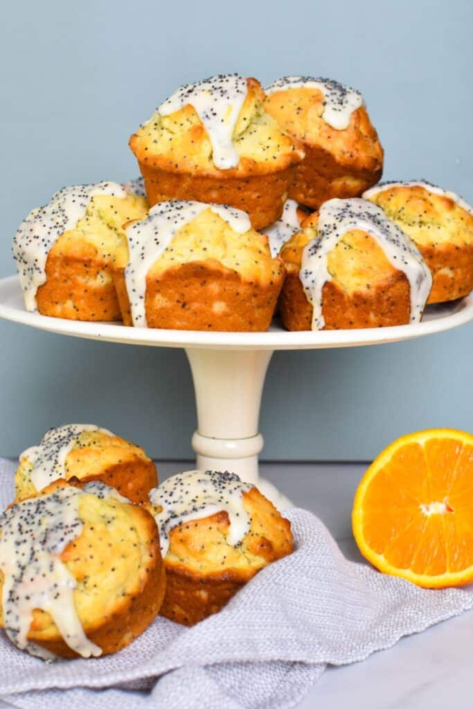 orange and poppy seed muffins on cake stand.