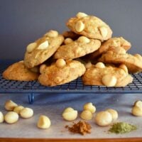 macadamia cookies on cooling tray with scattered nuts and spices