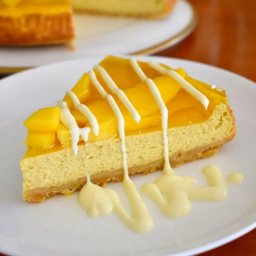 close up picture of slice of mango cheesecake