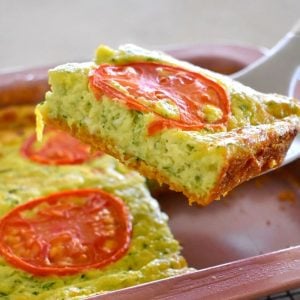 zucchini slice being lifted from tray