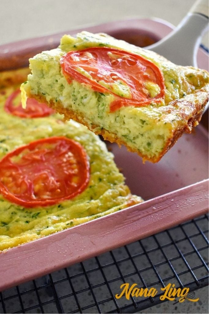 zucchini slice being lifted from tray