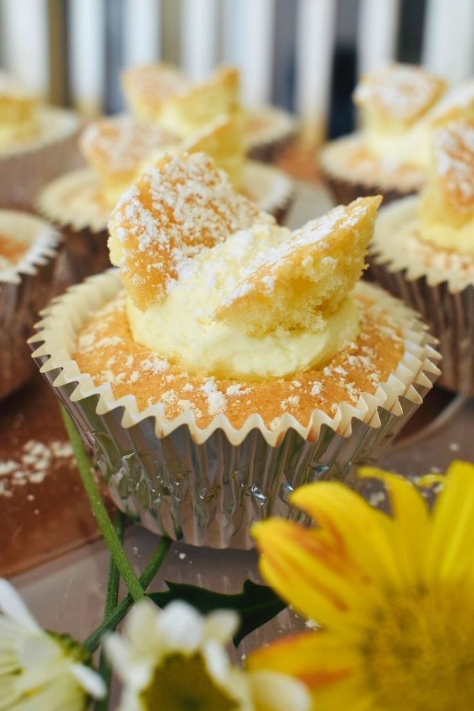 butterfly cupcakes on table with flowers
