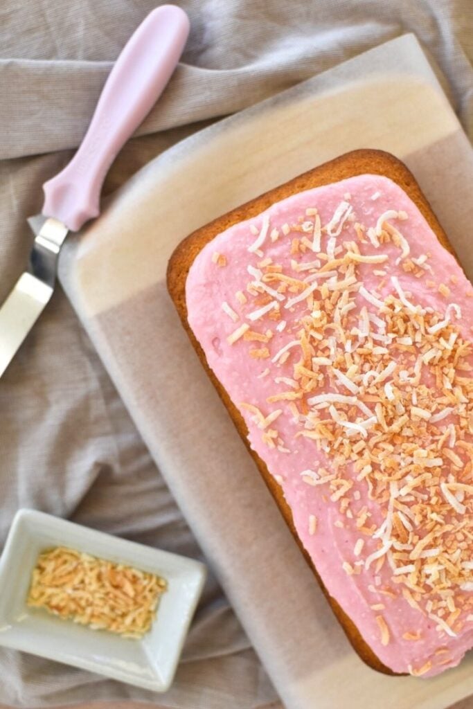 coconut cake with pink icing and toasted coconut topping