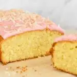coconut cake with pink icing and lightly toasted coconut