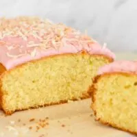 coconut cake with pink icing and lightly toasted coconut