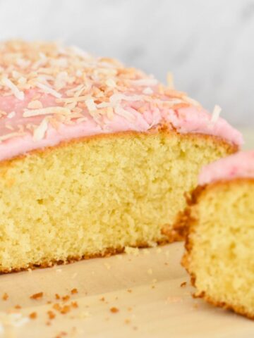 coconut cake with pink icing and lightly toasted coconut