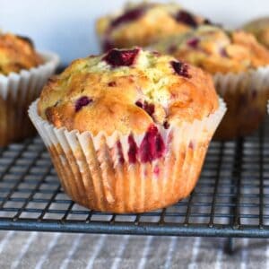 Raspberry and white chocolate muffin on cooling tray.