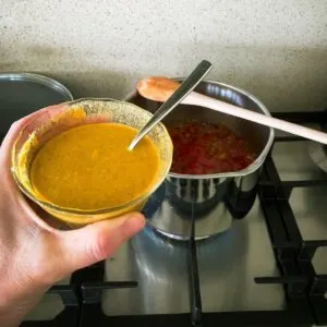 adding spice mixture to tomato relish