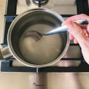 stirring sugar mixture for creme caramel
