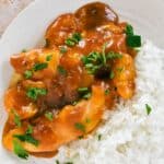Apricot Chicken on plate with rice.