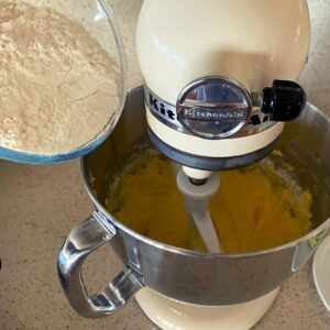 adding flour to sultana cake mix