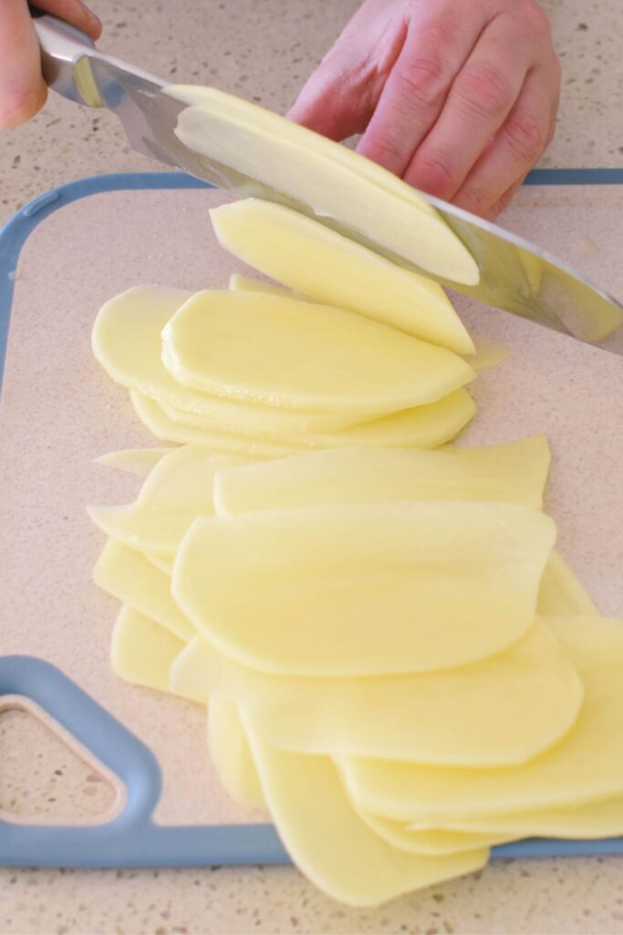 cutting potatoes for potato bake.