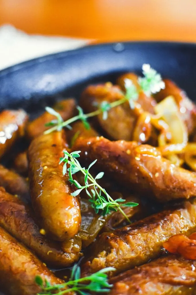 devilled sausages in pan.
