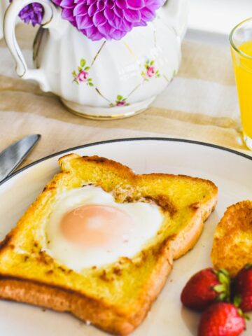 toad in a hole (egg cooked in hole in bread) on a plate.