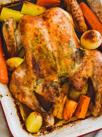 roasted butterfly chicken in baking pan.