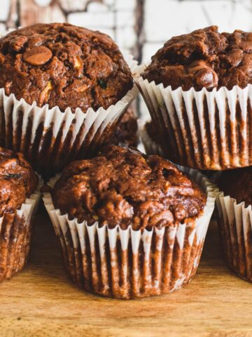 chocolate zuchhini muffins on wooden serving board.