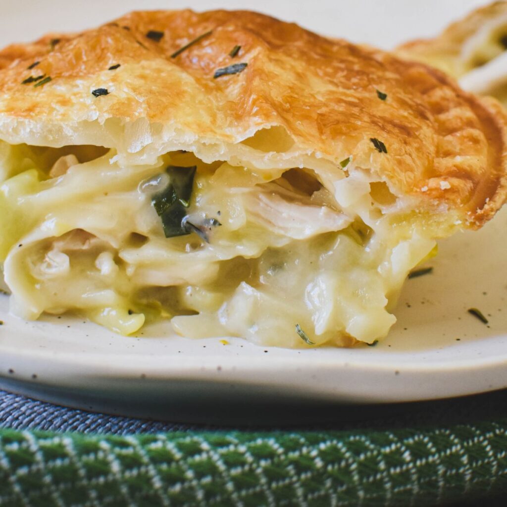 chicken and leek pie on plate showing inside of pie.