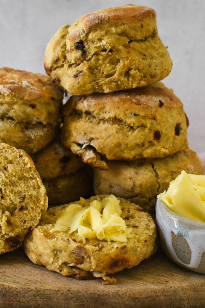 date scones piled up with butter on side.