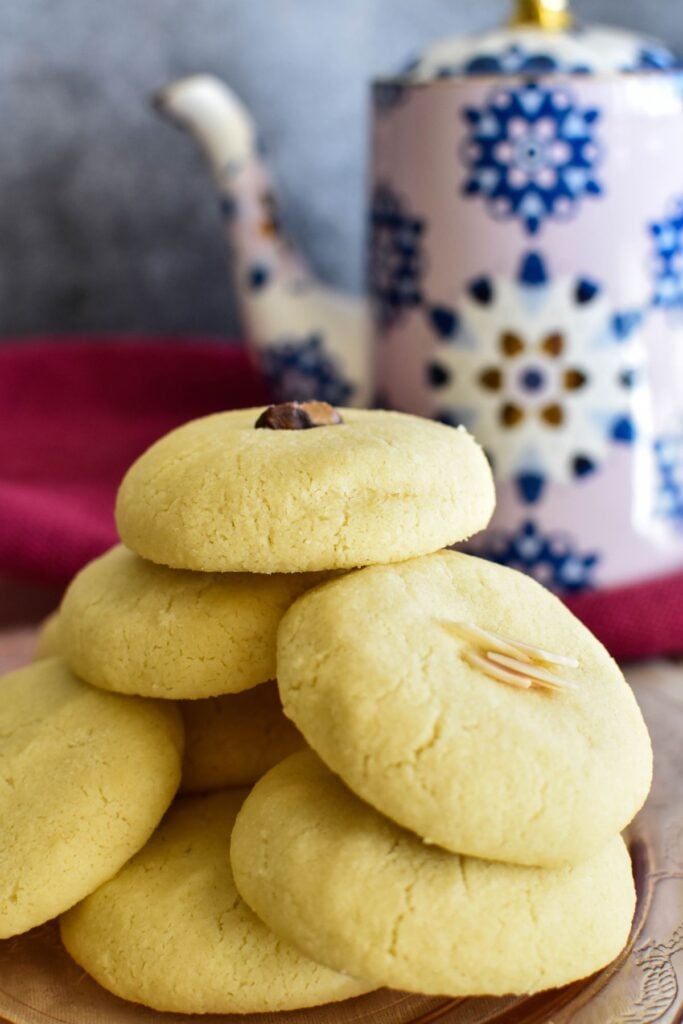 Lebanese shortbread cookies on plate with teapot in background.