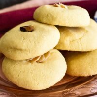 Lebanese butter cookies stacked on plate.