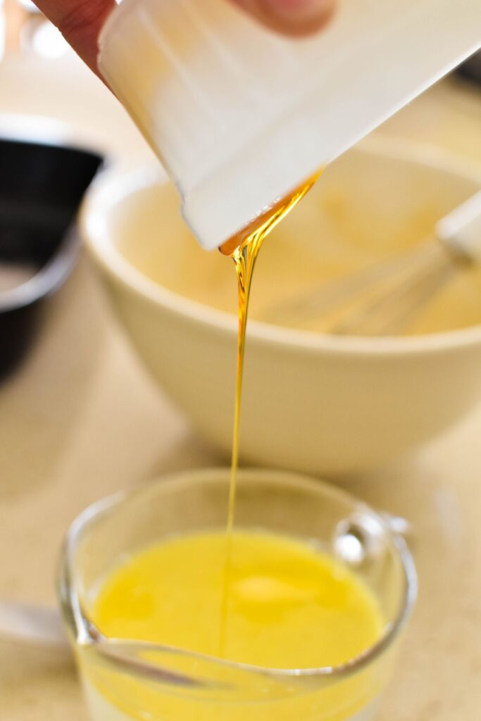 making butterscotch pudding, pouring golden syrup.