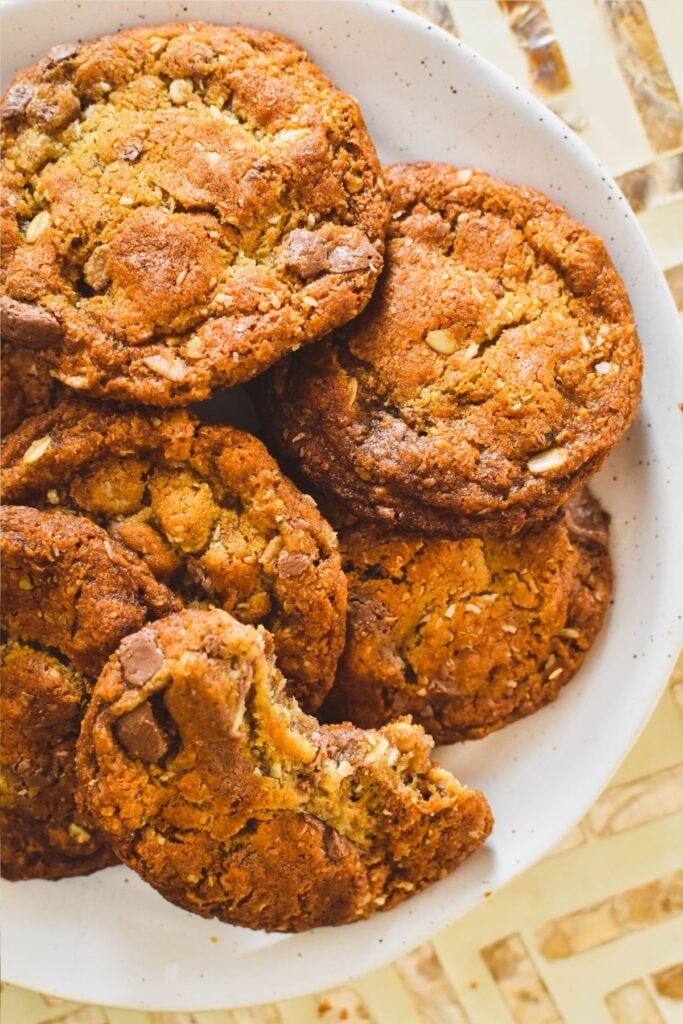 muesli cookies on plate with one having a bite out of it.