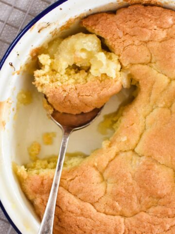 apple sponge in pie dish with spoon.