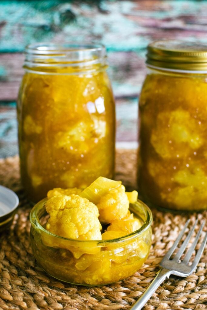 cauliflower pickles in jars and condiment dish.