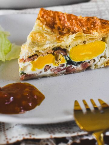 egg and bacon pie on plate.