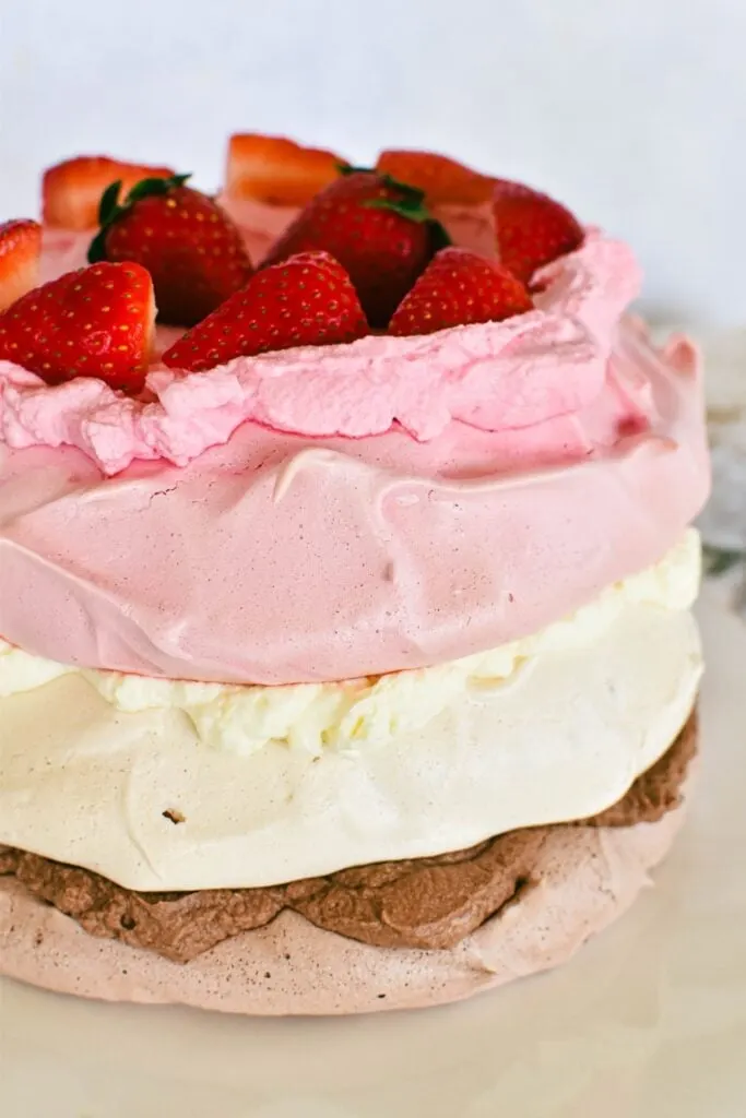 neapolitan pavlova with chocolate, vanilla and strawberry layer.