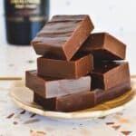Bailey's Fudge squares piled on plate.