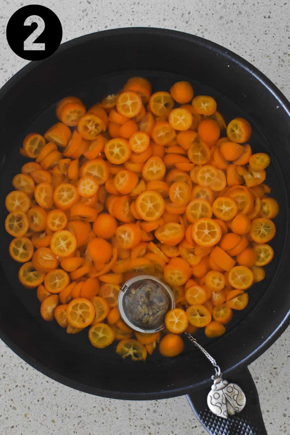 Sliced kumquats in pan.