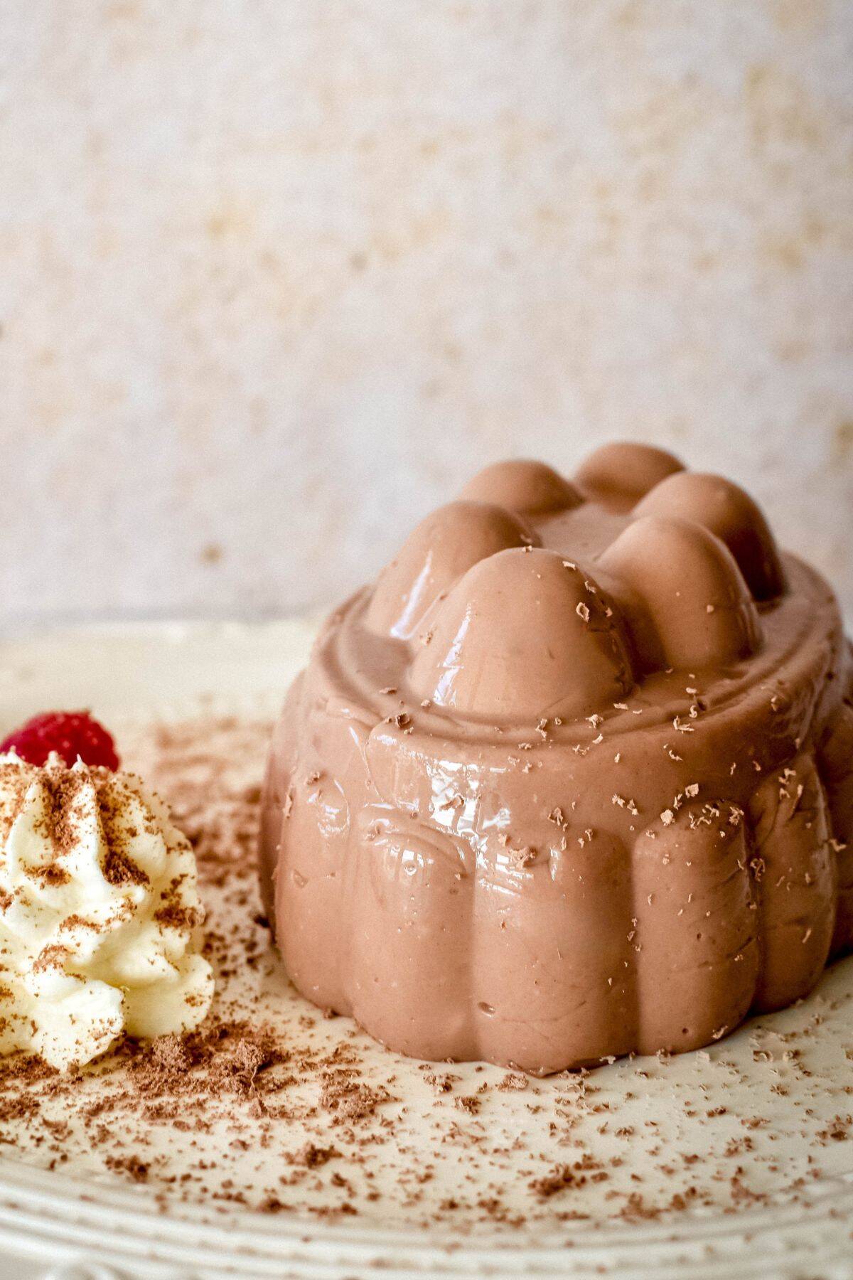 Chocolate Blancmange served with cream and raspberries.