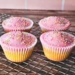 Patty Cakes, iced with a simple pink icing and decorated with pastel sprinkles.