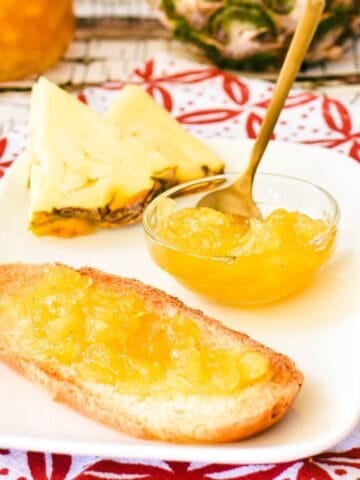 Pineapple Jam on toast and in jar in background.