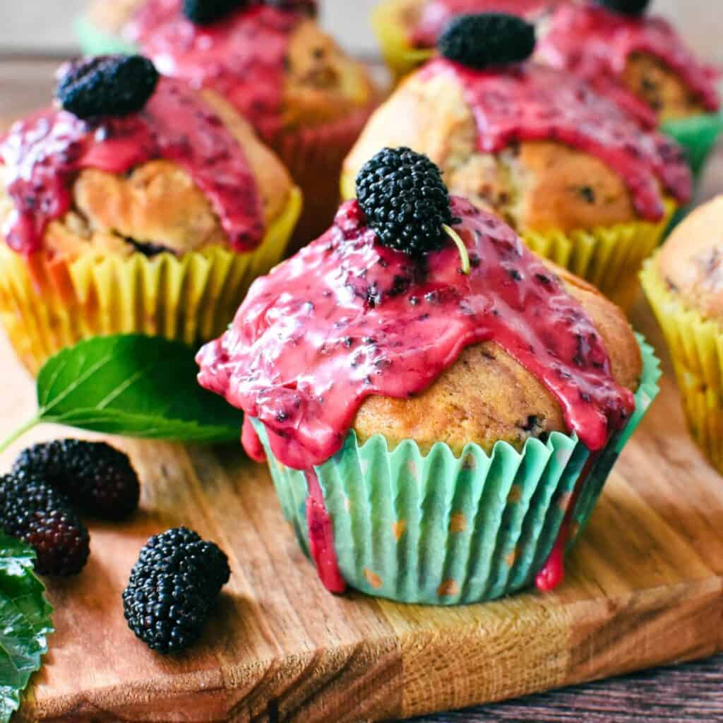 Mulberry Muffins on wooden board.