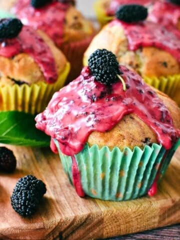 Mulberry Muffins on wooden board.