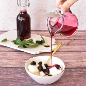 Mulberry Syrup being poured over ice cream.