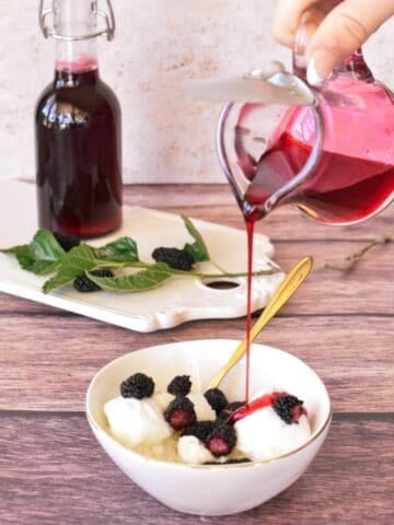 Mulberry Syrup being poured over ice cream.