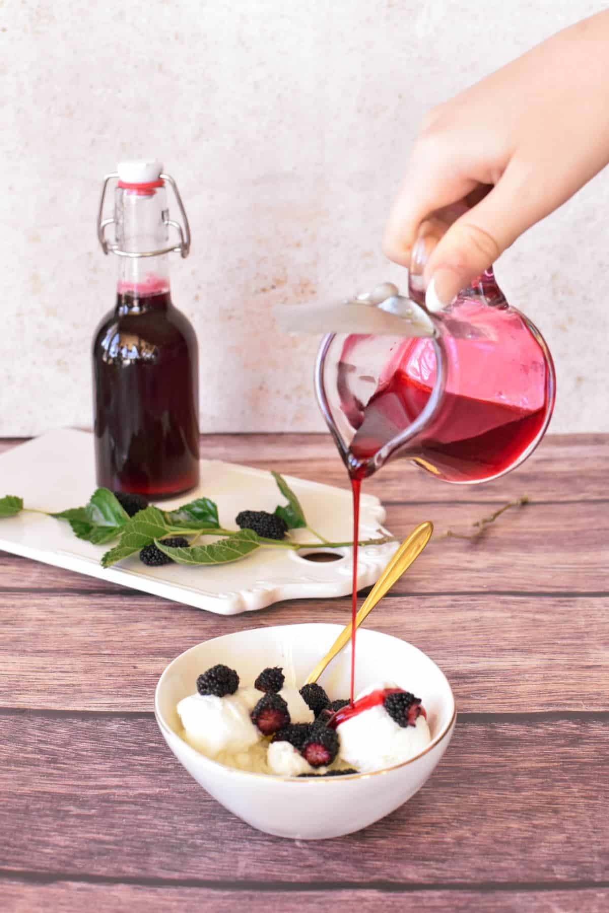 Mulberry Syrup being drizzled on ice cream.