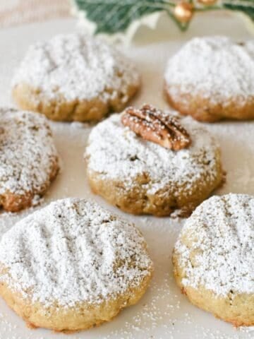 Pecan Biscuits dusted with icing sugar.