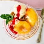 Peach Melba in glass bowl.